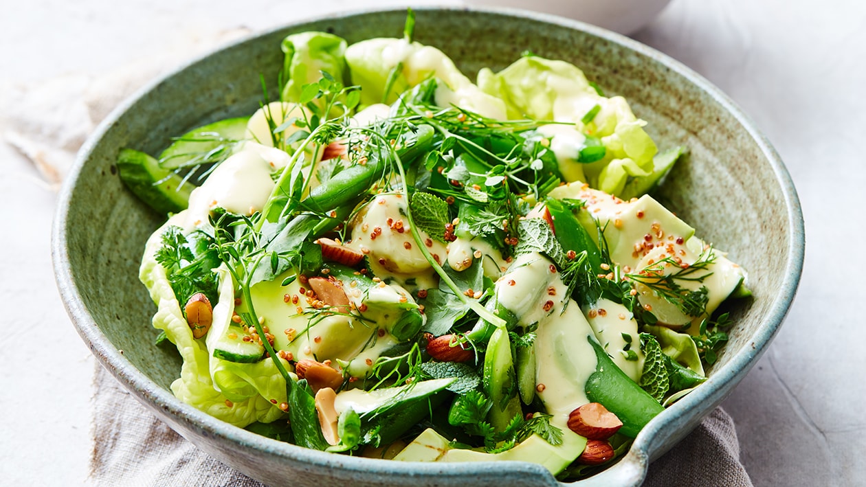Groene salade met boontjes, kruiden en gerookte amandelen